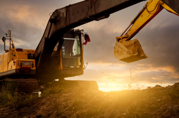 backhoe with sun in the background